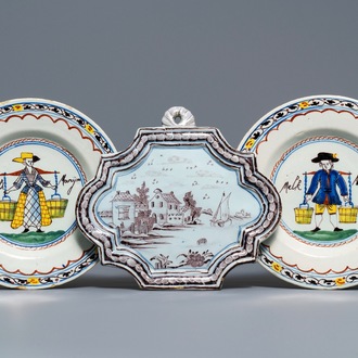 A pair of polychrome Dutch Delft 'Milkmaid' plates and a blue and manganese plaque, 18th C.