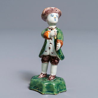 A polychrome Dutch Delft figure of a boy with a hat, 18th C.