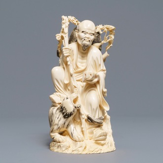 A Chinese ivory group of a sage with a tiger, 19/20th C.