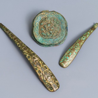 Two Chinese inlaid bronze belt hooks and a bronze ornament, Zhou or Han