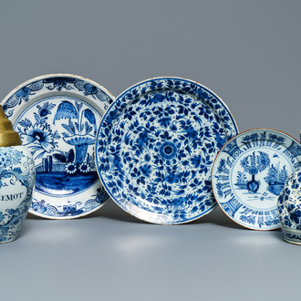 A Dutch Delft blue and white tobacco jar, a jug and three dishes, 18th C.