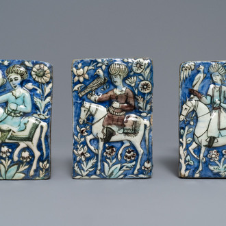 Three Qajar relief-moulded tiles with falconers, Iran, 19th C.