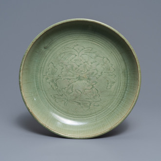 A Chinese Longquan celadon dish with underglaze peony design, Ming