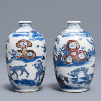 A pair of Chinese blue, white and underglaze red '16 monkeys' snuff bottles, Yongzheng mark, 19th C.