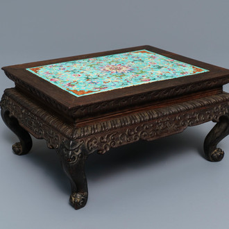 A Chinese carved wooden stand with famille rose plaque, 19th C.