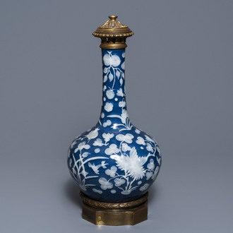 A Chinese blue-ground slip-decorated bottle vase with ormolu mounts, 19th C.