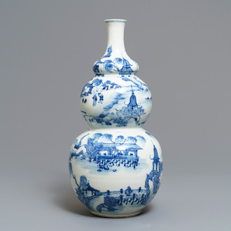 A Chinese blue and white triple gourd vase with circular landscape design, 19th C.