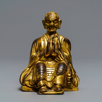 A Sino-Tibetan gilt bronze figure of a Lama, 19th C.