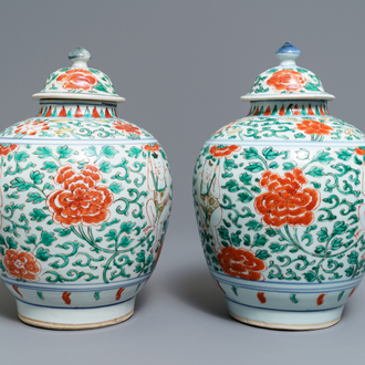 A pair of Chinese wucai vases and covers with boys among peonies, Transitional period