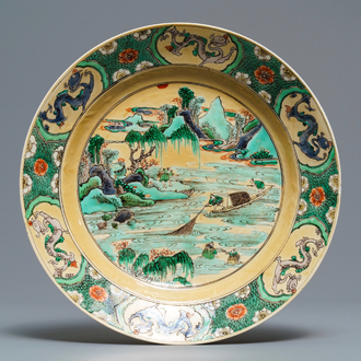 A Chinese famille verte café-au-lait ground plate with fishermen, Kangxi