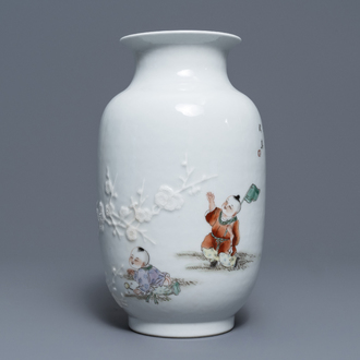 A Chinese famille rose relief-decorated vase with playing boys, Qianlong mark, Republic, 20th C.