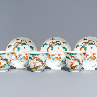 Three Chinese famille verte 'deer and monkey' cups and saucers, Tongzhi mark and of the period