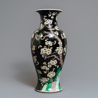 A Chinese famille noire 'magpie and prunus' vase, Kangxi