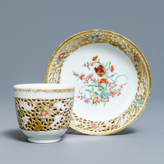 A reticulated Chinese famille rose cup and saucer, Qianlong