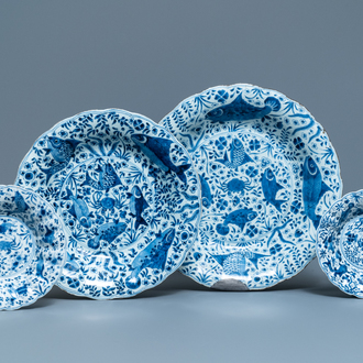 Two Chinese blue and white gadrooned 'crabs and carps' dishes and a pair of plates, Kangxi