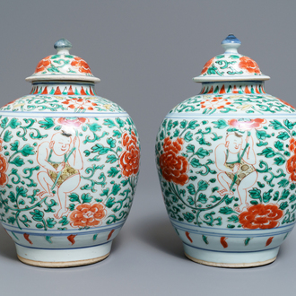 A pair of Chinese wucai vases and covers with boys among peonies, Transitional period