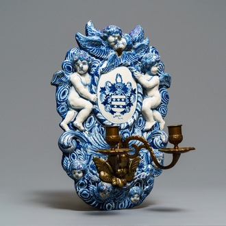 A large Dutch Delft blue and white armorial relief-decorated plaque, early 18th C.