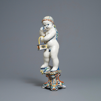 A polychrome Dutch Delft model of a boy, allegory of winter, 18th C.