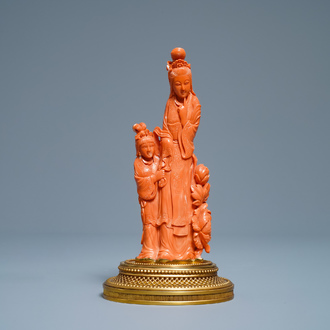 A Chinese carved red coral group of a lady and a girl, 19/20th C.