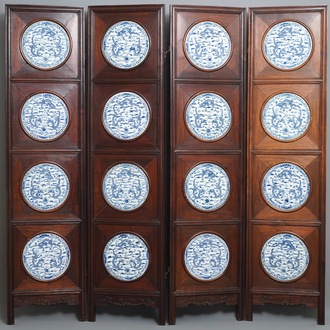 A Chinese wooden room divider with blue and white 'dragon' plaques, 19th C.