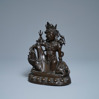 A Chinese silver-inlaid bronze figure of Guanyin on a dragon, Shisou mark, 18/19th C.