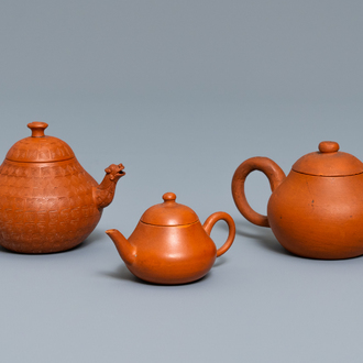 Three Chinese Yixing stoneware teapots and covers, impressed marks, 18/19th C.