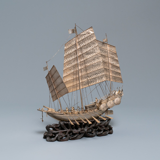 A large Chinese silver model of a junk on carved wooden stand, 19th C.