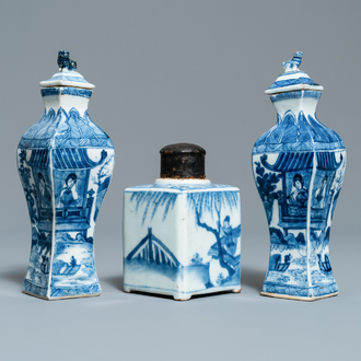 A pair of square Chinese blue and white covered vases and a tea caddy, Kangxi