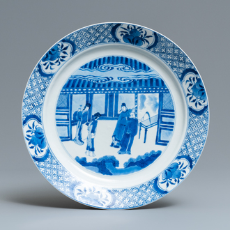 A Chinese blue and white dish with figures in an interior, Kangxi mark and of the period