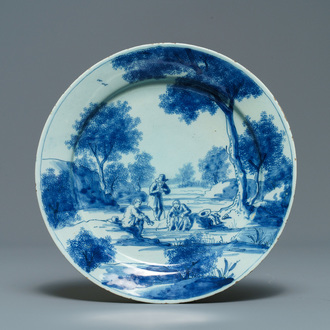 Een fijn blauw-wit Delfts bord met figuren in een landschap, 1e kwart 18e eeuw