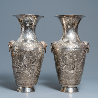 A pair of exceptional large Chinese relief-decorated silver vases, 19th C.