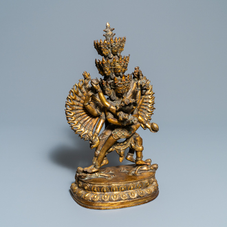 A large Sino-Tibetan coral-inlaid gilt bronze figure of Kapaladhara Hevajra, 18/19th C.