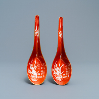 A pair of Chinese reverse-decorated iron red spoons, 19th C.