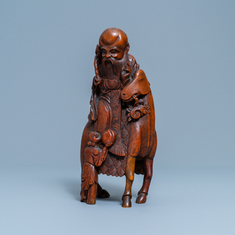 A Chinese carved bamboo group of Shou Lao on a deer, Ming