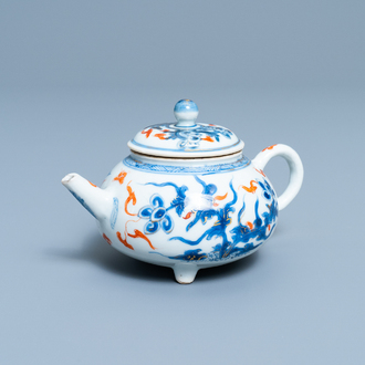 A rare Chinese blue, white, iron red and gilt tripod teapot and cover, Kangxi