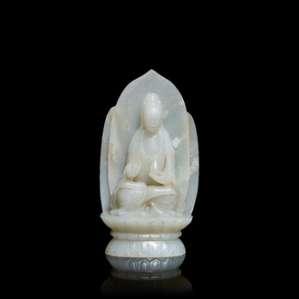 A Chinese pale celadon jade figure of Guanyin on a lotus throne, 19/20th C.