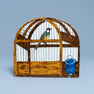 A polychrome Dutch Delft birdcage plaque, dated 1773