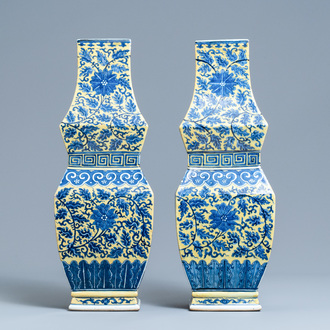 A pair of Chinese blue and white yellow-ground vases, 19th C.