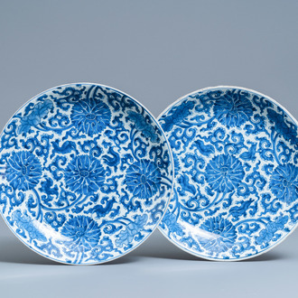 A pair of Chinese blue and white 'lotus scroll' chargers, Kangxi