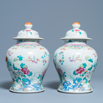 A pair of Chinese famille rose vases and covers, 19th C.