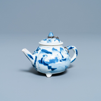 A Chinese blue and white tripod teapot with figures in a landscape, Kangxi