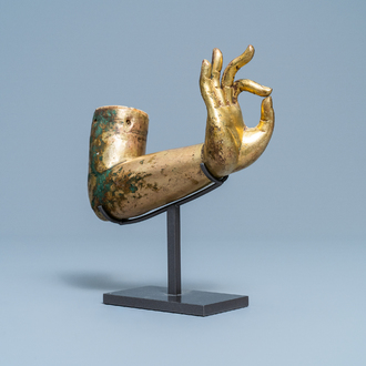 A Tibetan gilt bronze and copper alloy arm of Buddha, Ming