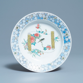 A Chinese famille rose 'ruby back' plate with a bird on a blossoming branch, Yongzheng