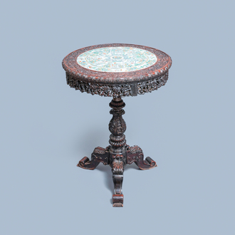 A Chinese carved wooden table with a large Canton famille verte plaque, 19th C.