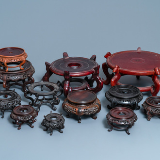 Twelve large round Chinese carved wooden stands, 19/20th C.