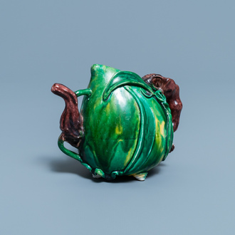 A Chinese verte biscuit peach-shaped 'cadogan' teapot, Kangxi