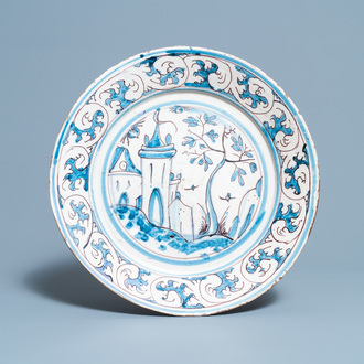 A blue, white and manganese Portuguese faience charger with a castle, 17th C.