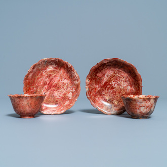 A pair of Chinese Shoushan soapstone gilt-decorated engraved cups and saucers, Kangxi