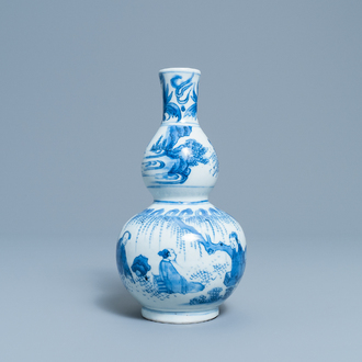 A Chinese blue and white double gourd vase with figures in a landscape, Transitional period