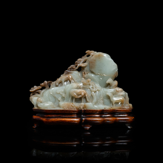 A Chinese mottled celadon and brown jade 'Eight horses of Mu Wang' carving, Qing